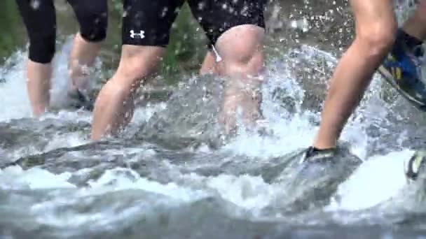 Teammates crossing river stream — Stock Video