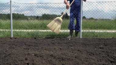 Süpürge kullanarak bahçıvan