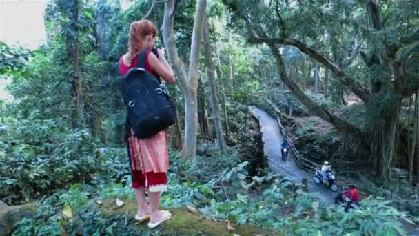 Woman tourist making photos of places around Bali — Stock Video