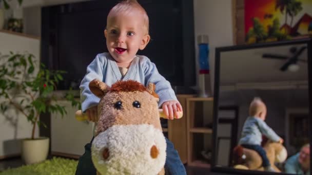 Child is smiling while riding a plush horse — Stock Video