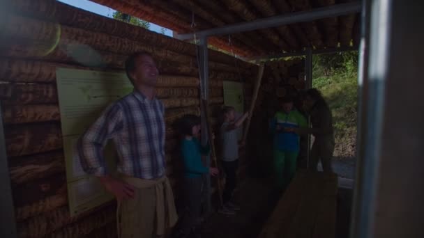 Пара тормозит в деревянном доме, полном детей — стоковое видео