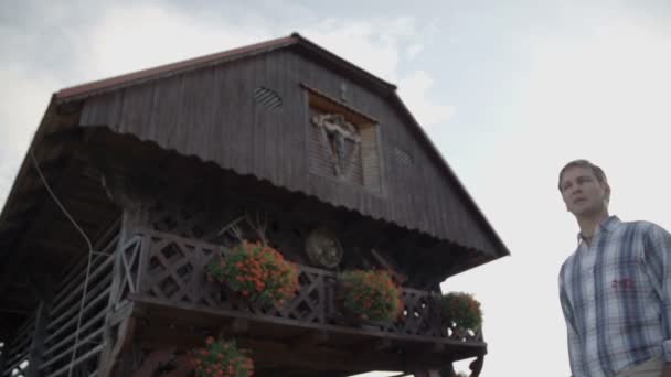 Couple on a hike passing the wooden hayrick — Stock Video