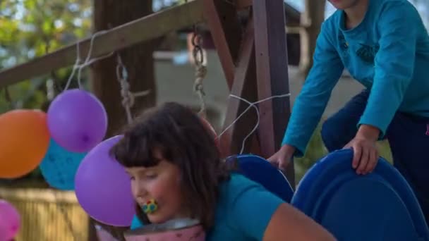 Sliding down the slide on a birthday party — Stock Video