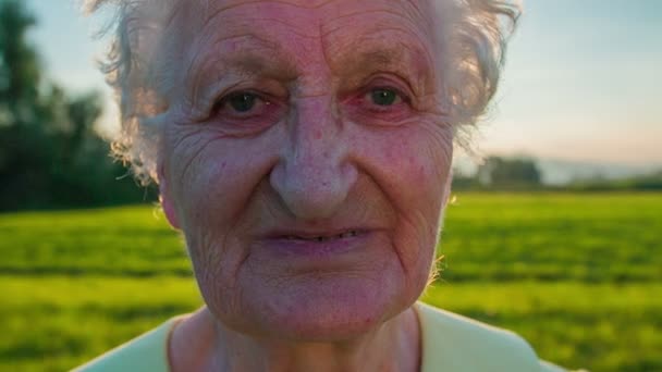 Tired but happy face of an old woman — Stock Video