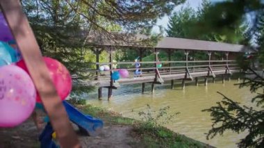 Tahta köprünün diğer tarafında parti üzerinde çalışan çocuk