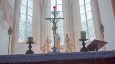 Close-up shot with the candles and cross on the altar