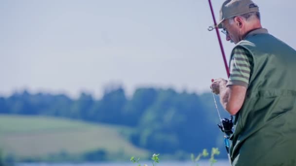 Pescador está lanzando su caña de pescar — Vídeos de Stock