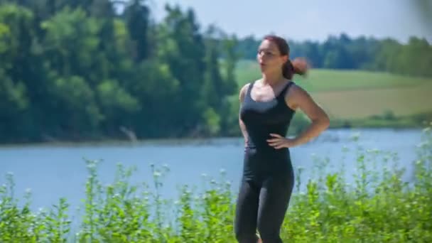 Couple is jogging around the lake — Stock Video