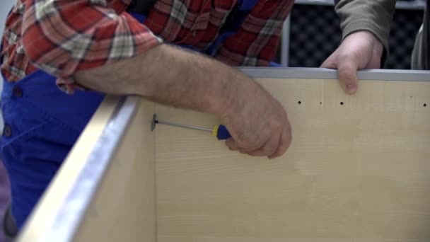 Man using screwdriver  white assembling  furniture — Stock Video