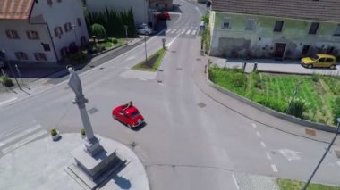Araba bir kasabada bir heykel çevresinde bir dönüş yapıyor
