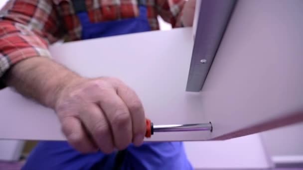 Man using screwdriver  white assembling  furniture — Stock Video