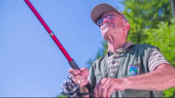 Fisherman  spooling his fishing rod — Stock Video