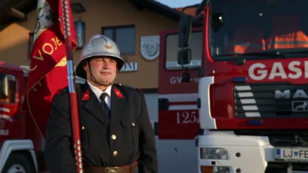 Brandweerman met een vlag in zijn hand — Stockvideo