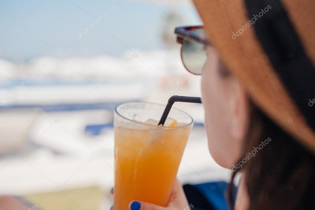 Woman In Drinking Fruit Cocktail At The Beach