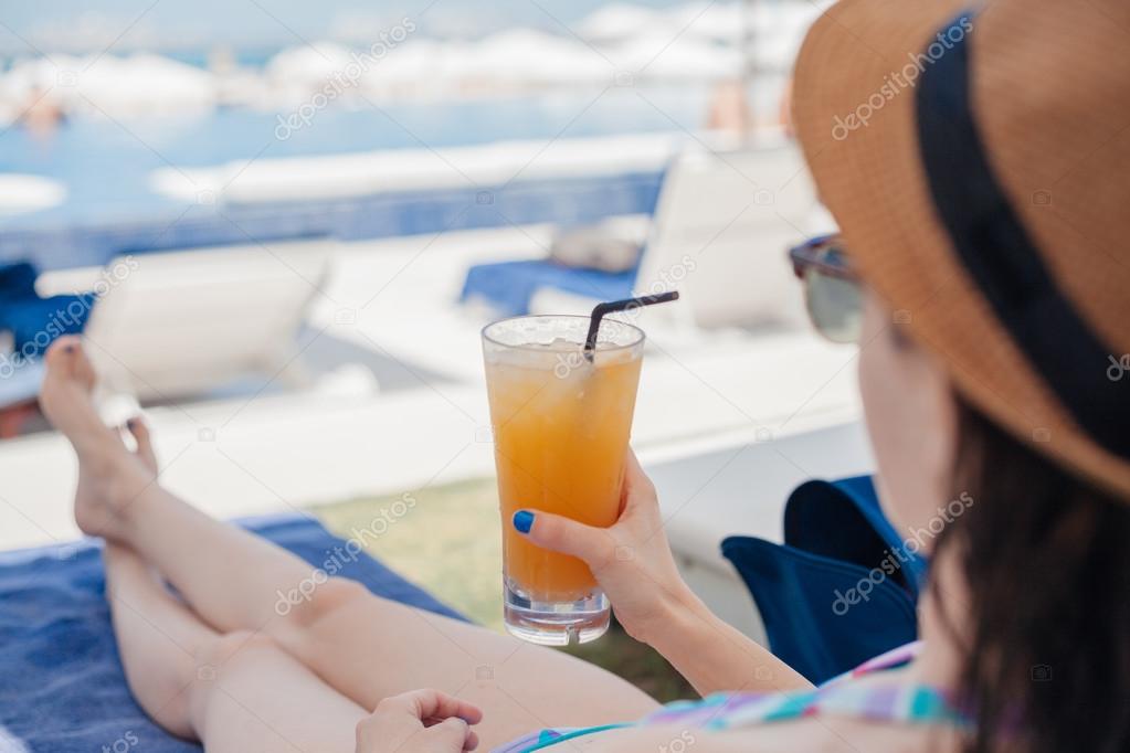 Woman In Drinking Fruit Cocktail At The Beach