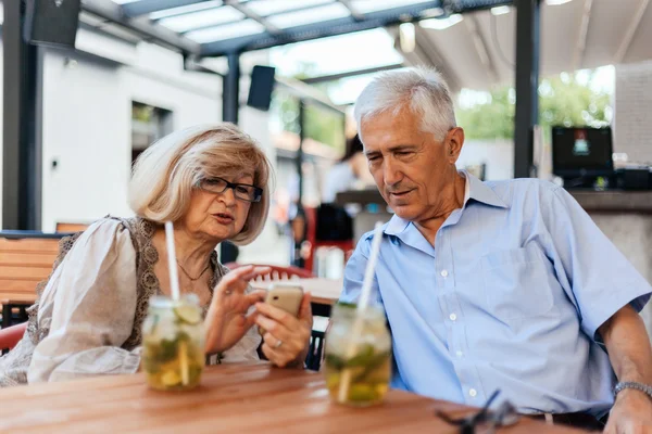 Ältere Paare im Café nutzen Technologie — Stockfoto