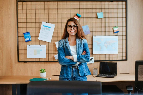 Attractive business woman in glasses standing in the modern office.