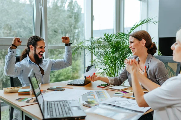 Mutlu gülümseyen iş adamı ofiste masada otururken sertifika alıyor..