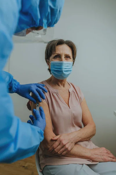 Médico en general protector y guantes haciendo la vacunación COVID-19 — Foto de Stock