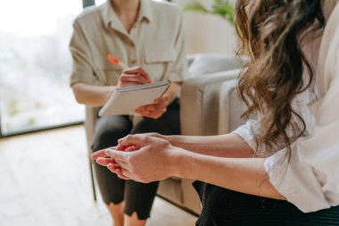 Danışmanlık sırasında genç bir kadının akıl sağlığı sorunları hakkında doktorla konuştuğu yakın çekim. Akıl sağlığı konsepti. Seçici odak.