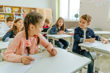 Elementary school students talking in the classroom