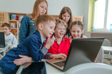 Elementary school students learning in the classroom using laptop