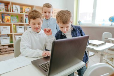 Elementary school students learning in the classroom using laptop