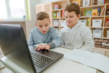 Elementary school students learning in the classroom using laptop