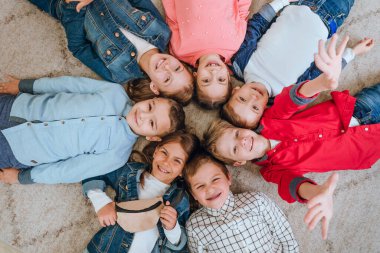 Friends lying on the floor looking at camera