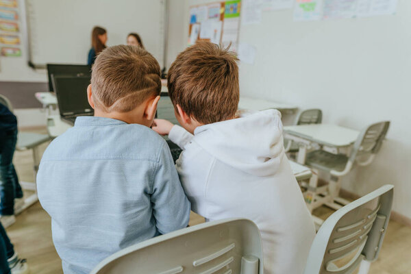 Elementary school students learning in the classroom using laptop