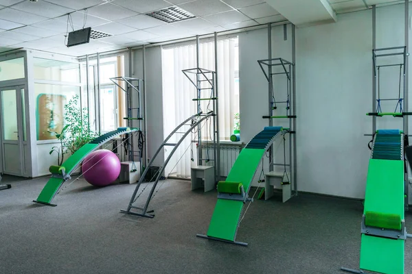 Interior of rehabilitation center gym with training apparatus
