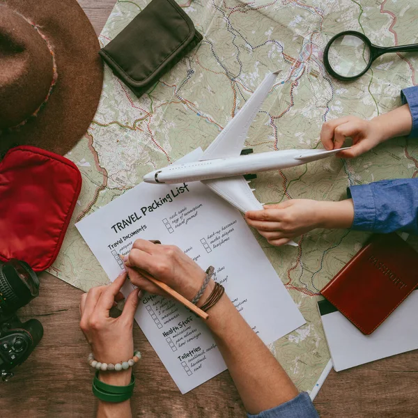 Travel essentials on the dark wooden background