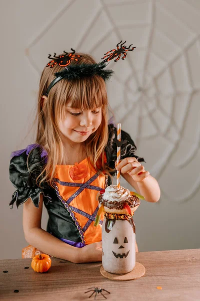 Portrait Little Girl Dressed Halloween Witch Costume Spider Headband Drinking — Stock Photo, Image