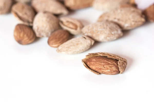 Almond on white background with a group at bottom, selective foc — Stock Photo, Image