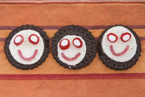 Smiling and funny cookies with sweets — Stock Photo, Image