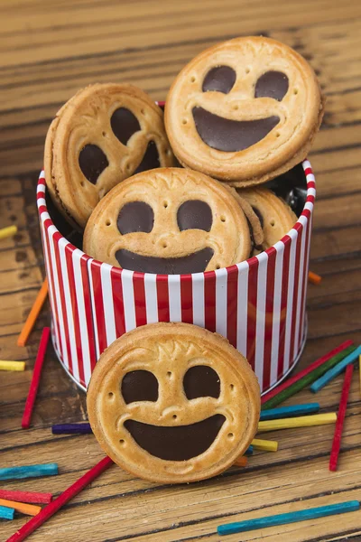 Round smiling chocolate cookies with colorful confetti — Stock Photo, Image