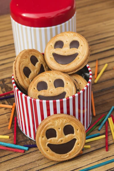 Round smiling chocolate cookies with colorful confetti — Stock Photo, Image