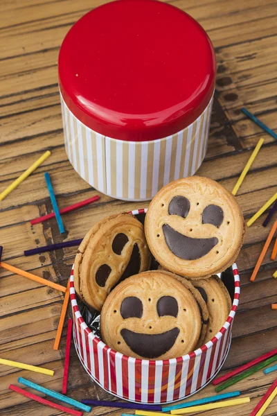 Round smiling chocolate cookies with colorful confetti — Stock Photo, Image