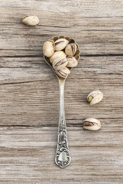 Pistachios in a vintage spoon — Stock Photo, Image
