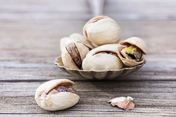Pistachios in a vintage spoon — Stock Photo, Image