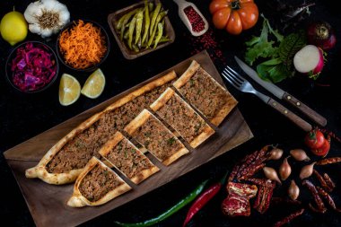 Traditional Turkish food, lahmacun and kiymali and kusbasili pide. Many kinds of traditional food on the rustic table.  clipart