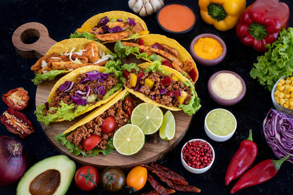 Taco with beef, pork and chicken. Variations of tacos. Mexican traditional cuisine. 