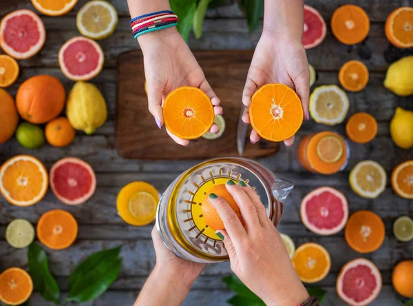 Squeeze the juice of many citrus fruits on the table. Healty life concept with fresh fruits.