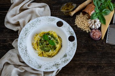 Parmesan peyniri, fesleğen, çam fıstığı ve diğer malzemelerle pesto sosu hazırlıyorum. Mutfak tezgahında yemek hazırlığı.. 