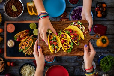 Many types of tacos on the table. Mexican street food concept.  clipart