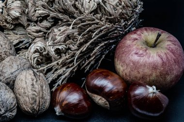 A composition of typically autumnal fruits such as chestnuts, walnuts or the Campanian Annurca apple, enhancing their beauty and detail.