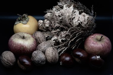 A composition of typically autumnal fruits such as chestnuts, walnuts, persimmons or the Campanian Annurca apple, enhancing their beauty and detail.