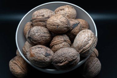 A composition of typically autumnal fruits such as walnuts, enhancing their beauty and detail.