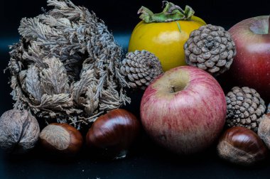 A composition of typically autumnal fruits such as chestnuts, walnuts, persimmons or the Campanian Annurca apple, enhancing their beauty and detail.