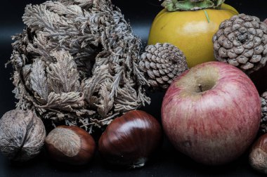 A composition of typically autumnal fruits such as chestnuts, walnuts, persimmons or the Campanian Annurca apple, enhancing their beauty and detail.